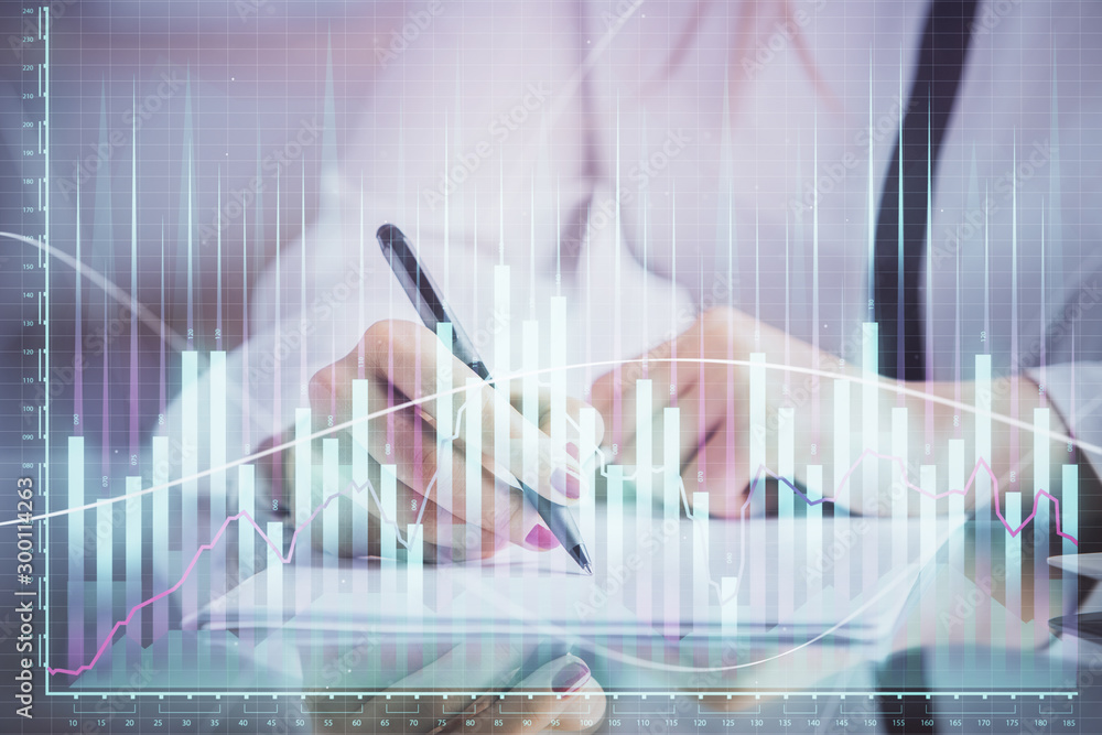 Double exposure of hands making notes with forex chart huds. Stock market concept. Double exposure of hands making notes with forex chart huds. Stock market concept.