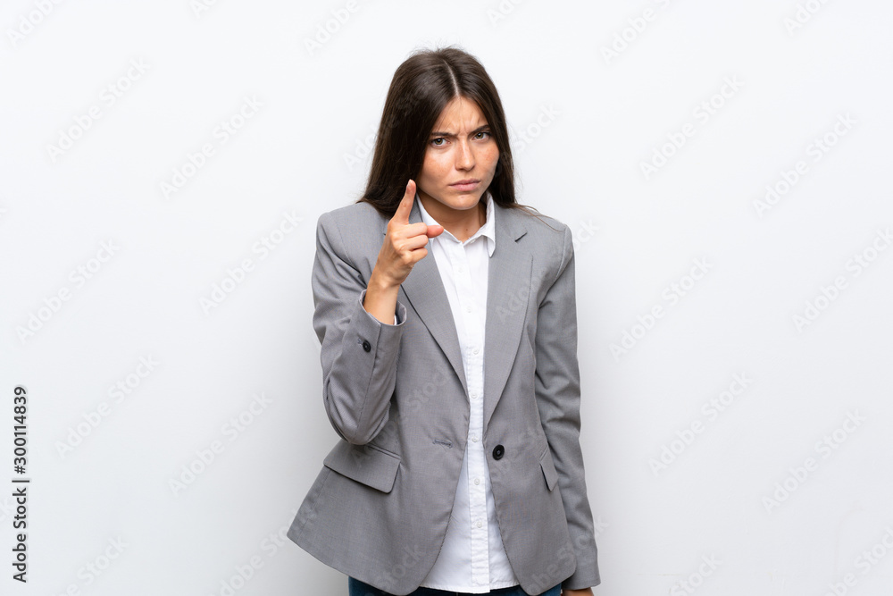 Young business woman over isolated white background frustrated and pointing to the front Young business woman over isolated white background frustrated and pointing to the front