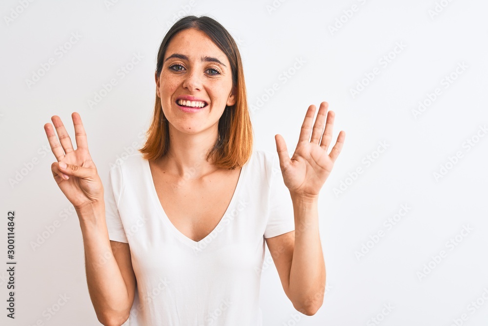 Beautiful redhead woman wearing casual white t-shirt over isolated background showing and pointing up with fingers number eight while smiling confident and happy. Beautiful redhead woman wearing casual white t-shirt over isolated background showing and pointing up with fingers number eight while smiling confident and happy.