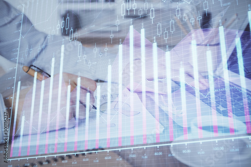 Multi exposure of stock market graph with man working on laptop on background. Concept of financial analysis. © peshkova
