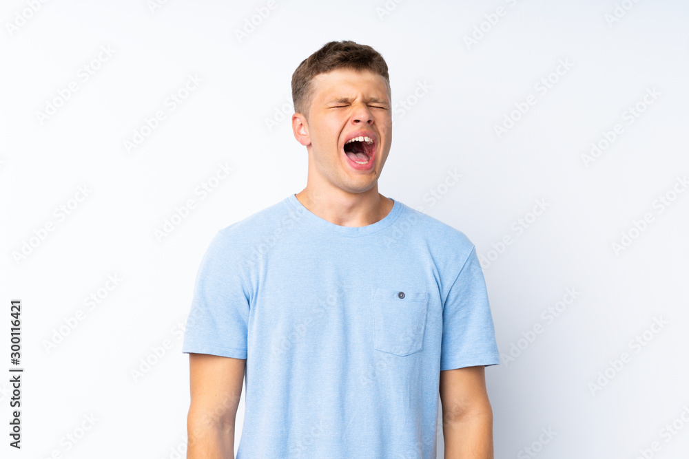 Young handsome man over isolated white background shouting to the front with mouth wide open Young handsome man over isolated white background shouting to the front with mouth wide open