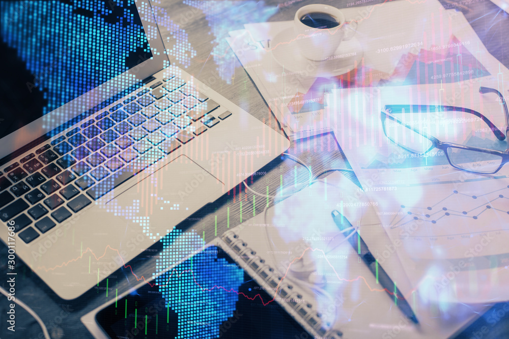 Financial graph colorful drawing and table with computer on background. Double exposure. Concept of international markets.