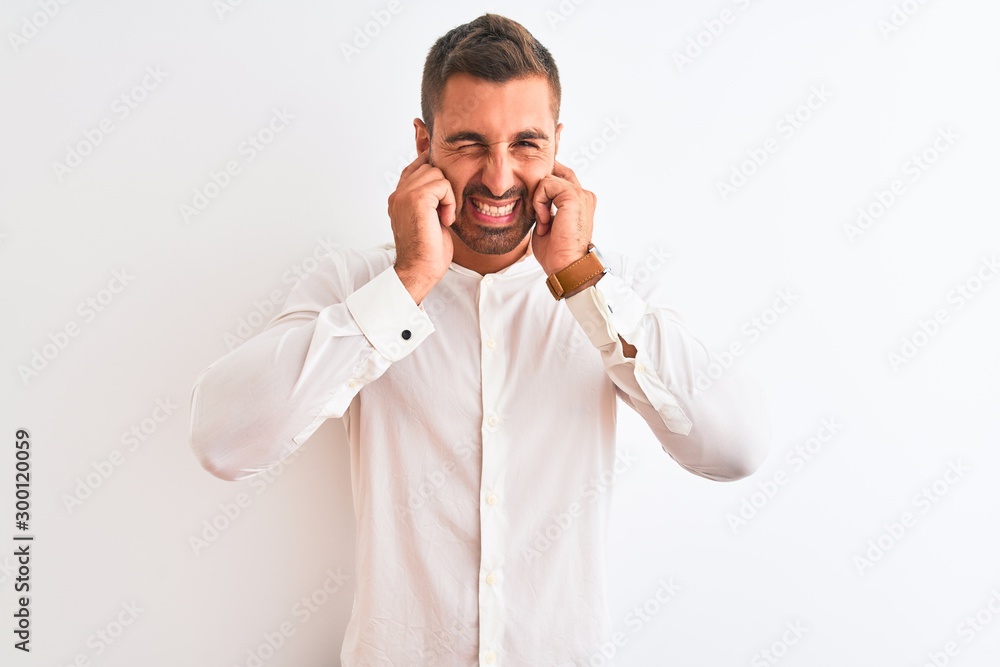 Young handsome business man wearing elegant shirt over isolated background covering ears with fingers with annoyed expression for the noise of loud music. Deaf concept. Young handsome business man wearing elegant shirt over isolated background covering ears with fingers with annoyed expression for the noise of loud music. Deaf concept.