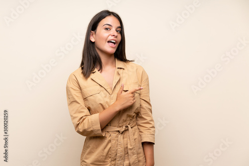 Young girl over isolated background surprised and pointing side