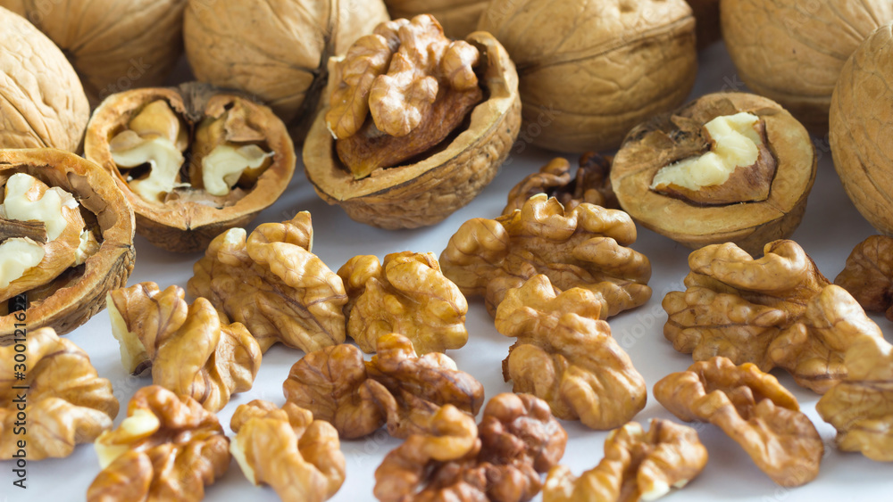 Walnut kernels and crushed nuts on a white background Walnut kernels and crushed nuts on a white background