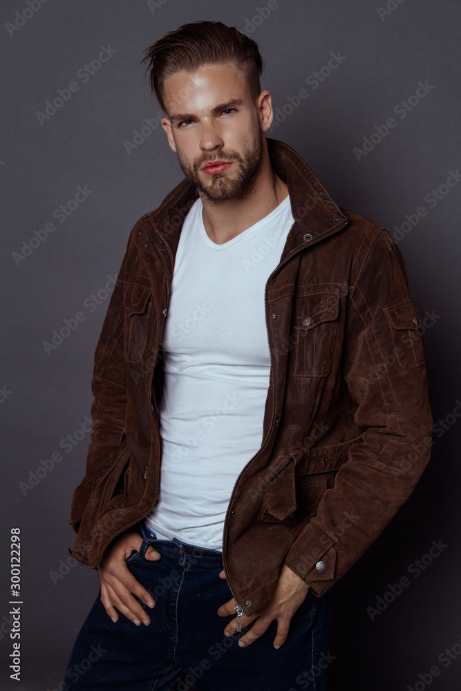 Muscle strong beautiful stripped male model with casual cloathes ongrayisolated font background
