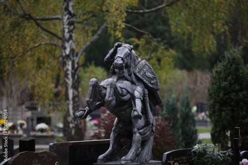 statue of a knight on a horse in a cemetery in Poland