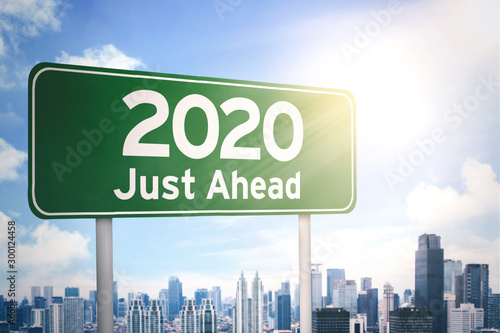 Green signboard with a text of 2020 just ahead © Creativa Images