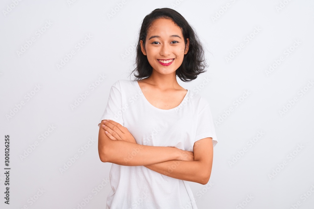 Young chinese woman wearing casual t-shirt standing over isolated white background happy face smiling with crossed arms looking at the camera. Positive person. Young chinese woman wearing casual t-shirt standing over isolated white background happy face smiling with crossed arms looking at the camera. Positive person.