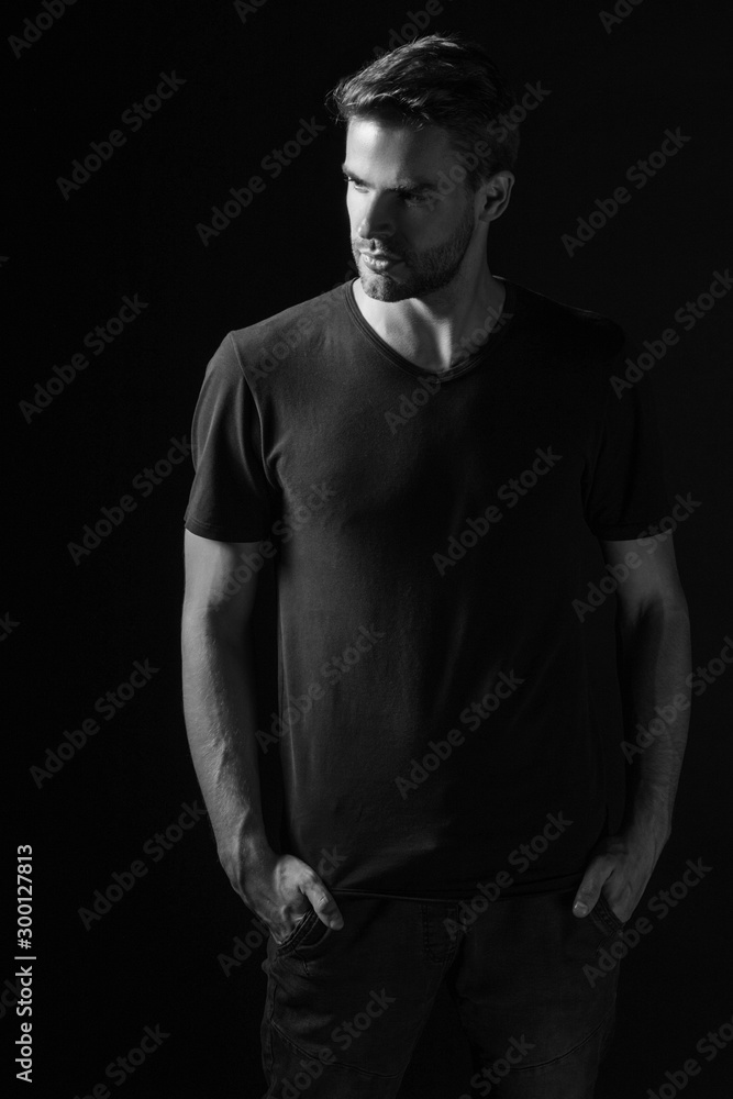 Black and White Muscle strong beautiful stripped male model in casual cloath on black isolated font background Black and White Muscle strong beautiful stripped male model in casual cloath on black isolated font background