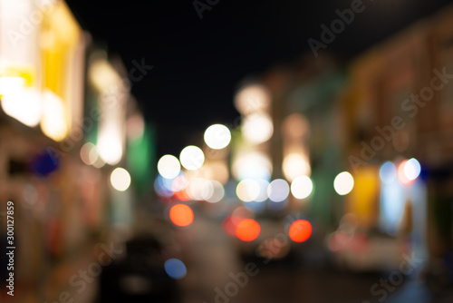 Fototapeta Naklejka Na Ścianę i Meble -  Abstract  colorful light bokeh in small town..Defocused of light street at phuket old town in the evening.