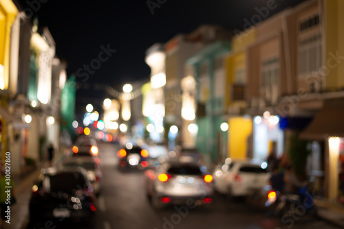 Abstract colorful light bokeh in small town..Defocused of building and cars traffic on the road at phuket old town in the evening.