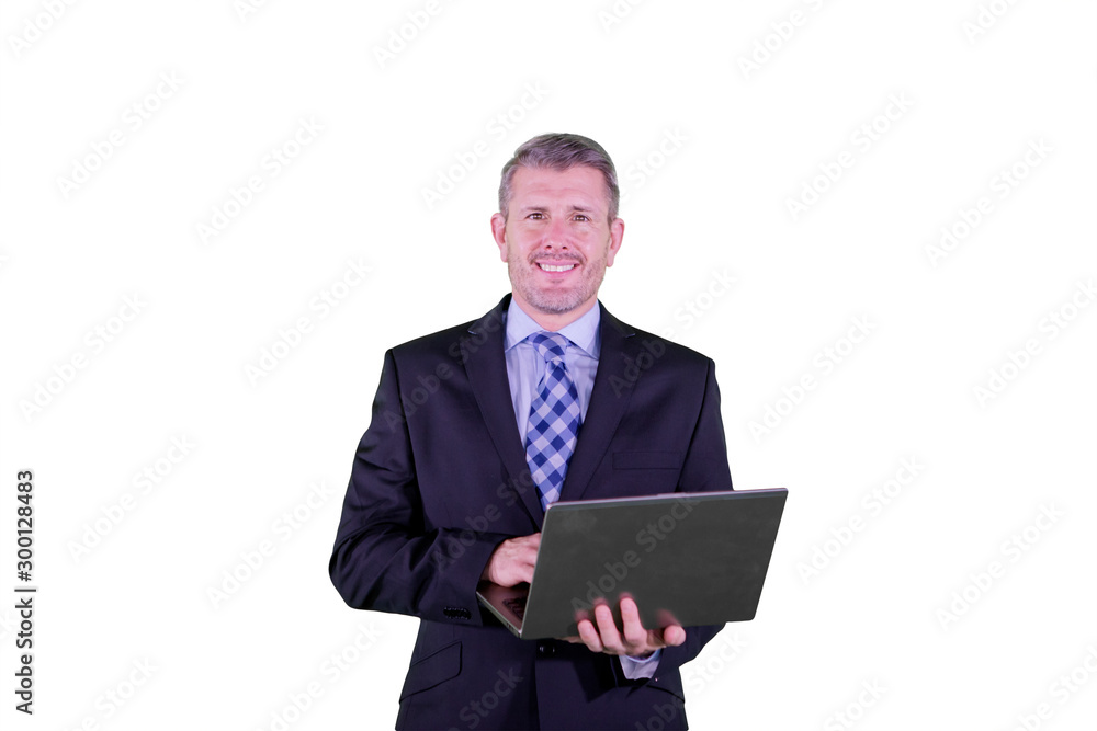 Smiling businessman using a laptop on studio Smiling businessman using a laptop on studio