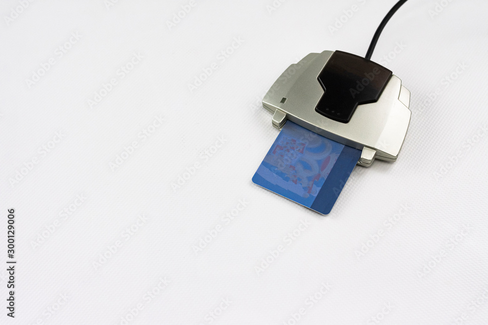 Electronic card reader for digital identification of people and perform economic transactions through a computer system or computer on white background Electronic card reader for digital identification of people and perform economic transactions through a computer system or computer on white background