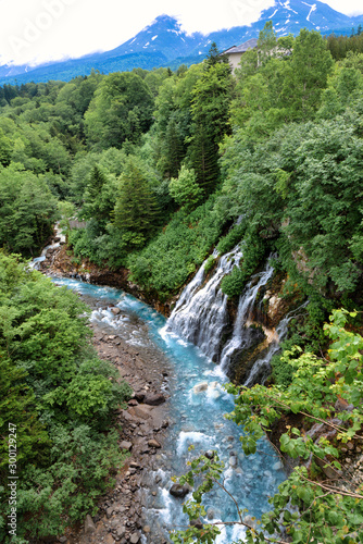 Scenery of shirahige's waterfall and Biei river. The water of this river flows into the blue pond at the downstream. Biei Hokkaido, Japan