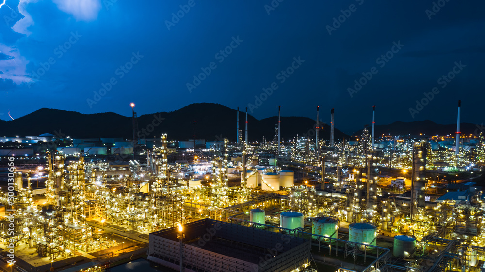 Naklejka premium twilight cityscape zone refinery industry factory and storage tank