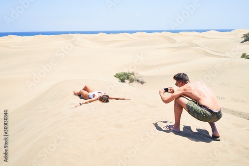 Young beautiful couple making photo at the beach