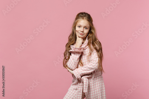 Little cute one kid girl 4-5 years old wearing rose clothes isolated on bright pink wall background, children studio portrait. People sincere emotions, childhood lifestyle concept. Mock up copy space.