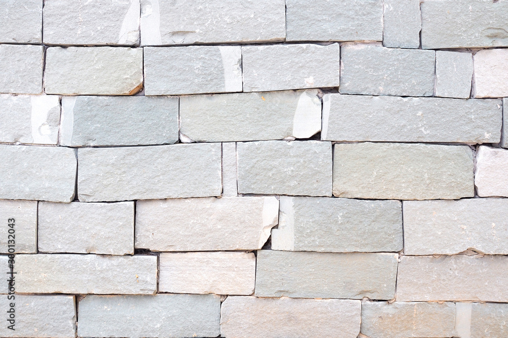 Naklejka premium Grey brick wall and rough sand stone wall background