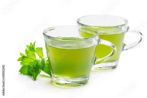 Green mint tea in clear glass cups isolated on white