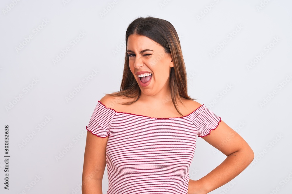 Portrait of beautiful young woman standing over isolated white background winking looking at the camera with sexy expression, cheerful and happy face. Portrait of beautiful young woman standing over isolated white background winking looking at the camera with sexy expression, cheerful and happy face.