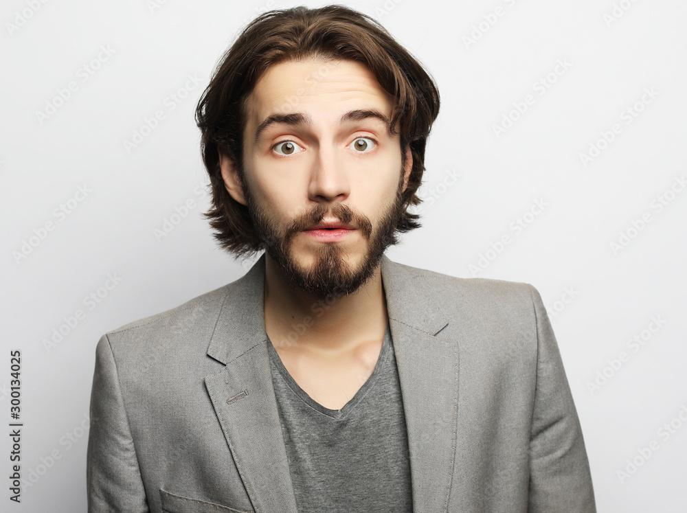 lifestyle, fashion and people concept: Portrait of young man posing over white background lifestyle, fashion and people concept: Portrait of young man posing over white background