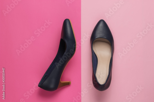 Classic women's high heel shoes on color paper background. Stylish shoes. Minimalistic fashion still life.