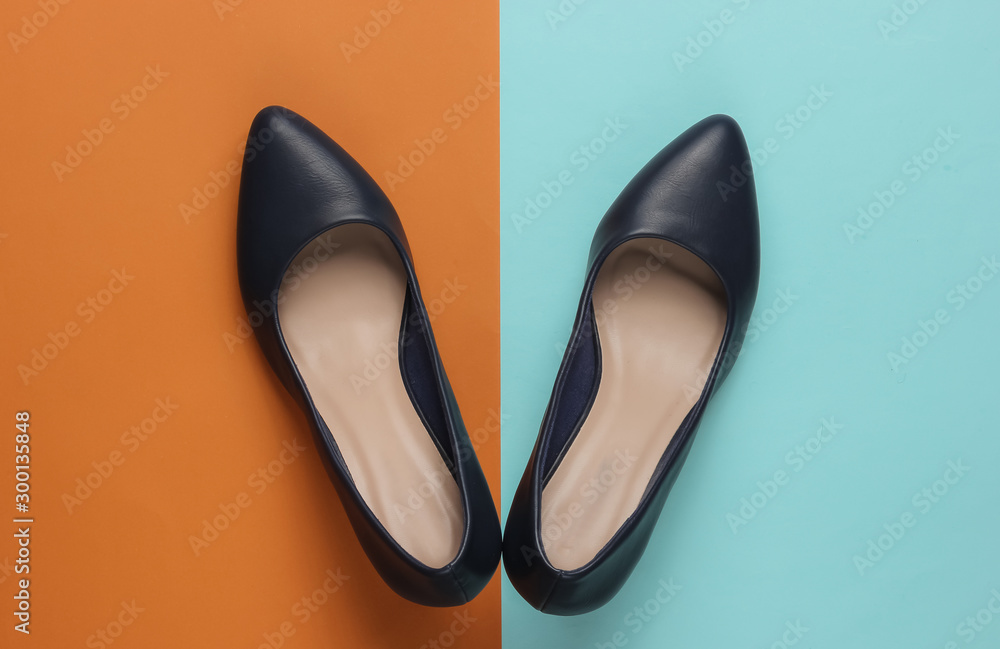 Classic women's high heel shoes on color paper background. Stylish shoes. Minimalistic fashion still life. Classic women's high heel shoes on color paper background. Stylish shoes. Minimalistic fashion still life.