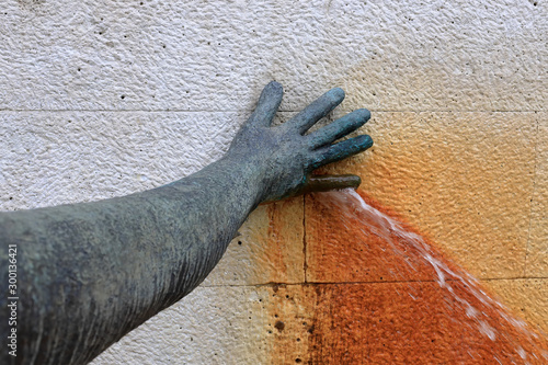 Hand plugging a water leak