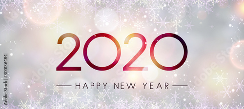 Blurred shiny Happy New Year 2020 banner with snowflakes.