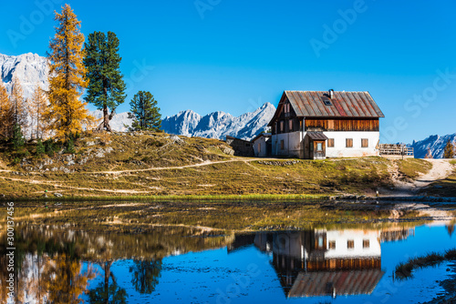 Golden reflections on the Federa lake. Dreamlike Dolomites. Italy