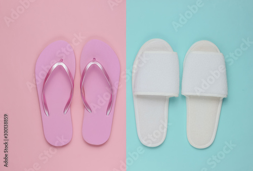 Slippers and flip-flops on colored paper background. Minimalistic fashion concept. Top view