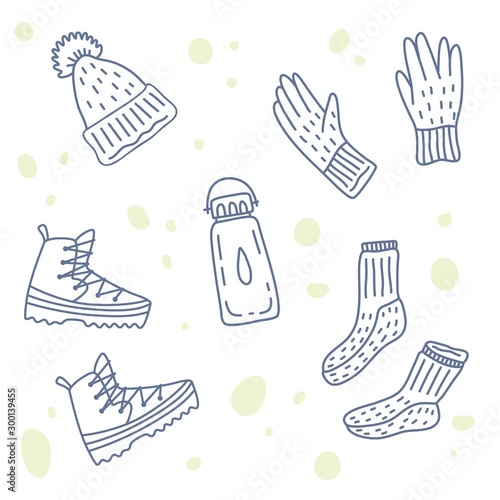 Vector illustration of hiking or touristic equipment. Warm hat, wool socks, gloves, trekking shoes, bottle of water. Set of icons. Doodle handdrawn style.