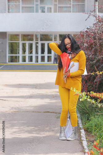  Female student in yellow clothes near the institute