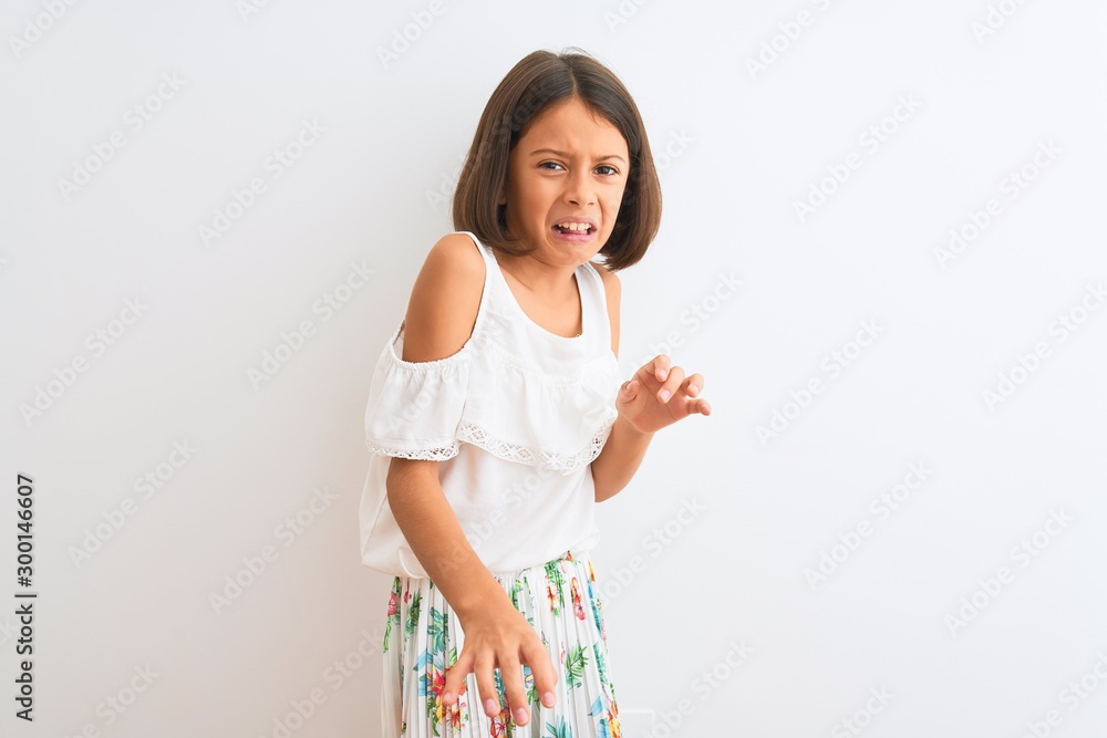 Young beautiful child girl wearing casual dress standing over isolated white background disgusted expression, displeased and fearful doing disgust face because aversion reaction. With hands raised Young beautiful child girl wearing casual dress standing over isolated white background disgusted expression, displeased and fearful doing disgust face because aversion reaction. With hands raised