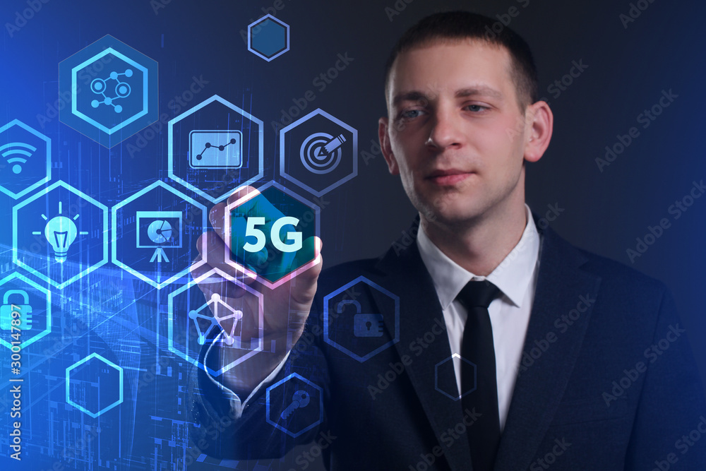 Business, Technology, Internet and network concept. Young businessman working on a virtual screen of the future and sees the inscription: 5G Business, Technology, Internet and network concept. Young businessman working on a virtual screen of the future and sees the inscription: 5G