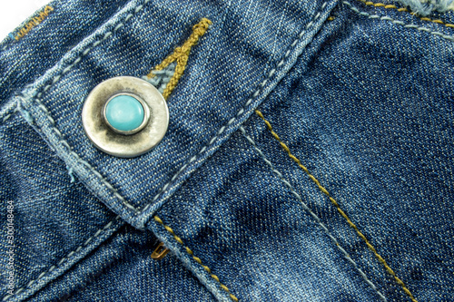 Close up of Blue jeans,Detail of vintage jeans texture with pocket studs and stitch with selective focus.