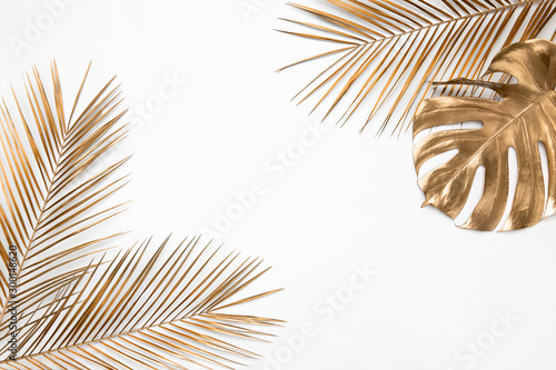 Vászonkép Golden tropical leaves on white background