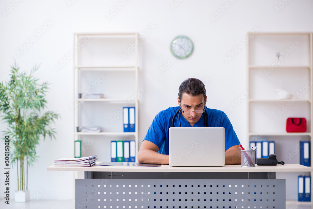 Young male doctor working in the clinic Young male doctor working in the clinic