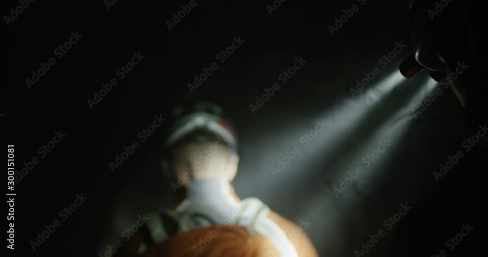 Two enduro racers navigating a dark smoky cave in slow motion follow shot Two enduro racers navigating a dark smoky cave in slow motion follow shot
