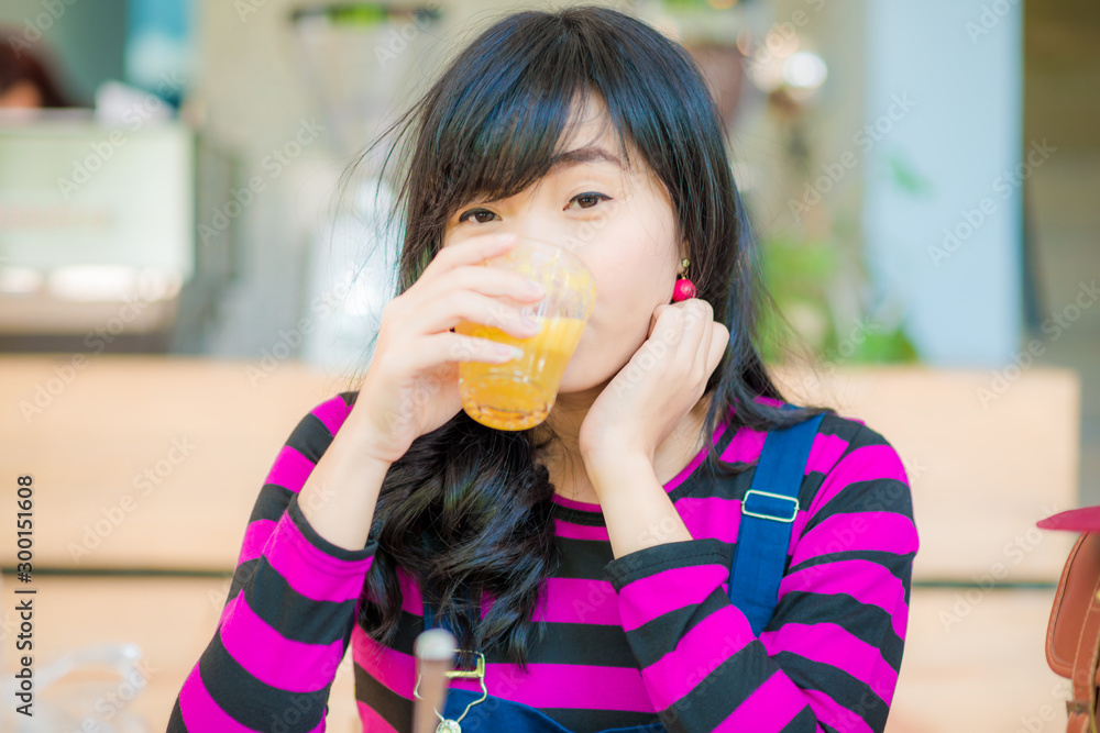 Woman drinking orange juice smiling Woman drinking orange juice smiling