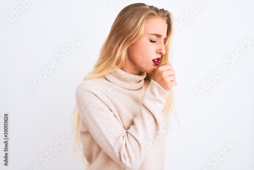 Young beautiful woman wearing turtleneck sweater standing over isolated white background feeling unwell and coughing as symptom for cold or bronchitis. Healthcare concept.