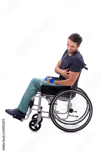 Young disabled man doing physical exercises isolated on white