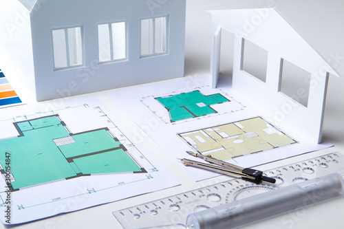 Architectural company. Architect. Office of the architectural bureau. Small copy of the house. Drawings on the architect's desk. Architectural decisions. Work with floor plans. Matching.