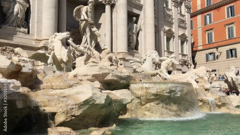 Magnificent sculptures depicting men and horses rest on marble and travertine stones composing the Trevi Fountain in the historic center of Rome, vertical movement of the camera Magnificent sculptures depicting men and horses rest on marble and travertine stones composing the Trevi Fountain in the historic center of Rome, vertical movement of the camera