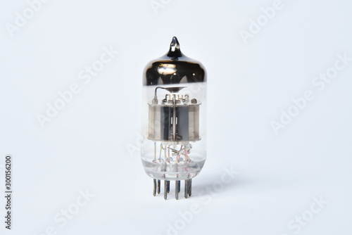 Old electronic tubes lamp, transistor and radio tube isolated on white background. photo