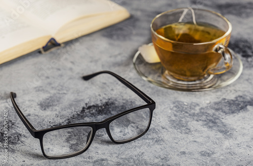 Glasses and a book on a table.