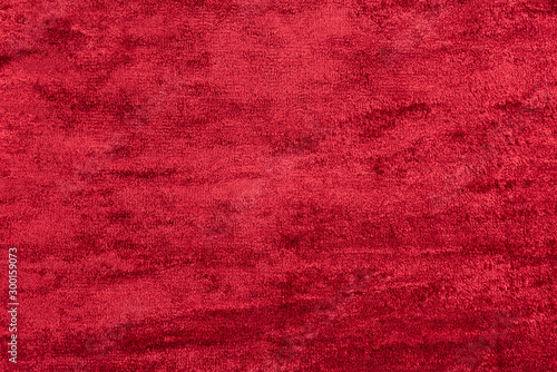 Red velour. Background from textured fabric.