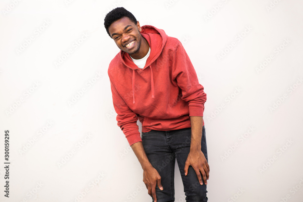 young african american man laughing by white background young african american man laughing by white background