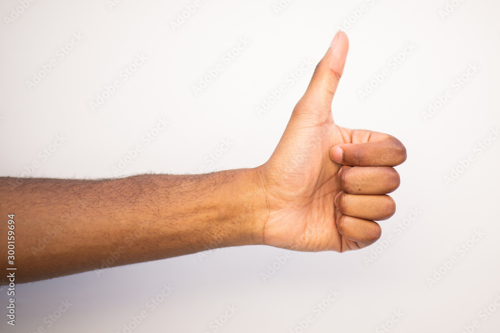 black man arm with thumbs up hand sign